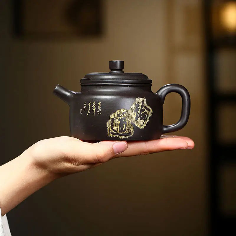 Dark Zisha clay Yixing teapot with gold inscriptions from Celestial Script Yixing collection
