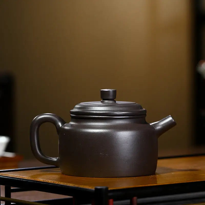 Brown ceramic Yixing Zisha Teapot with Celestial Script design crafted from Zisha clay