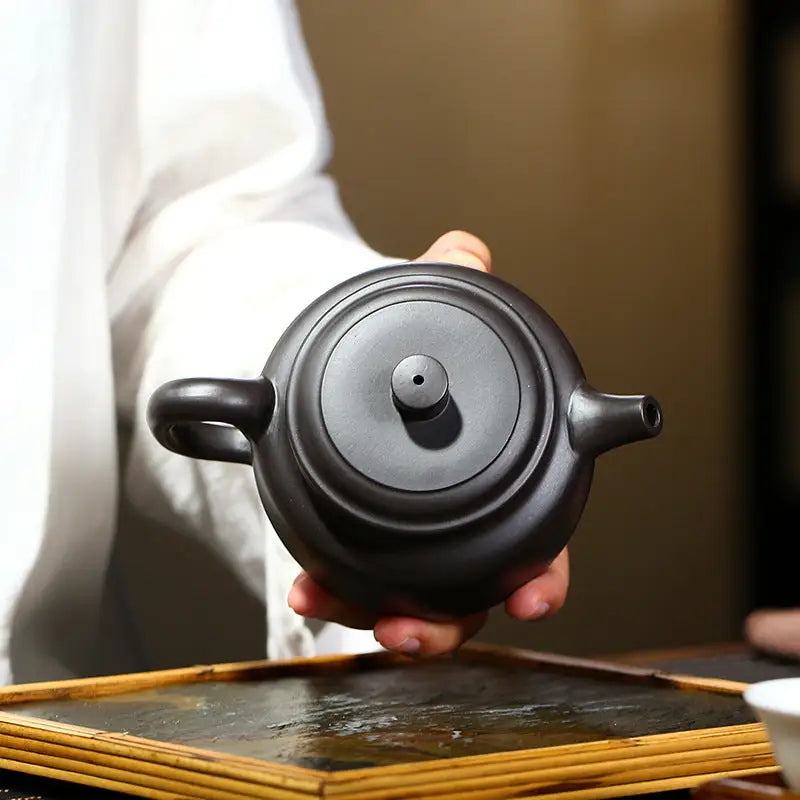Round black Yixing Zisha teapot from Celestial Script Yixing collection in Zisha clay