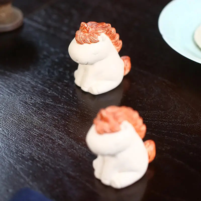 Two small ceramic unicorn figurines for Celestial Unicorn tea pets guide and feng shui energy