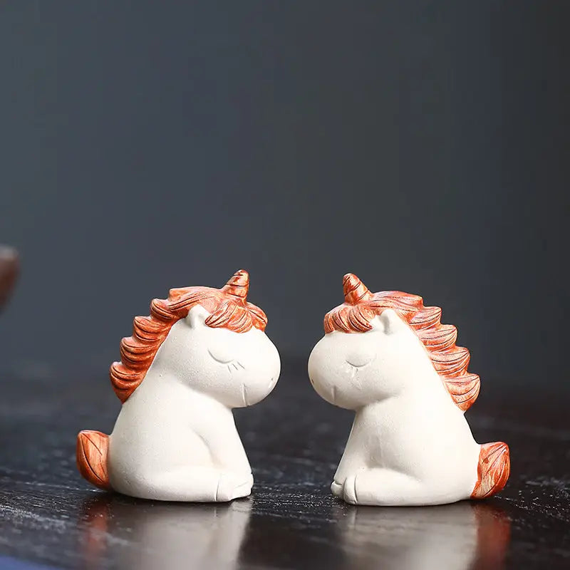 Celestial Unicorn tea pet figurines with white bodies and orange manes for feng shui energy