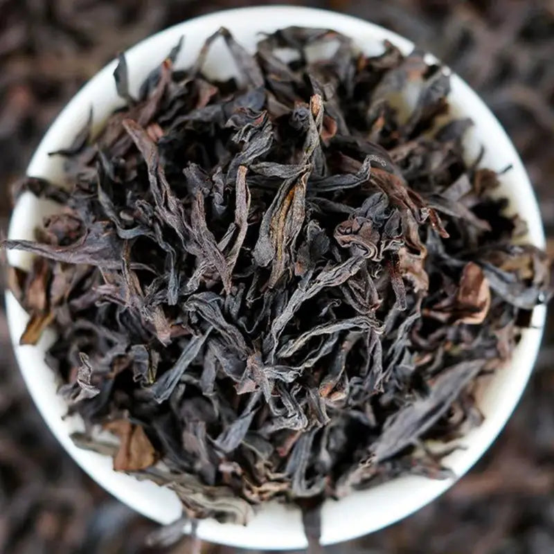 Loose dark dried tea leaves for Cinna Mon Rock Tea, perfect for teapots and tea sets