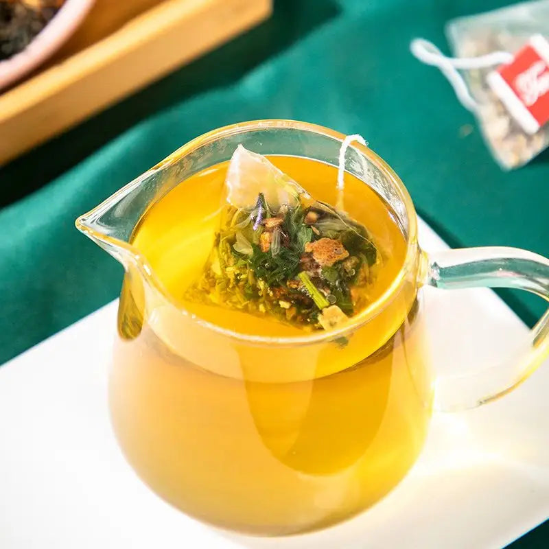 Glass teapot with tea bag showcasing colon cleansing tea with tangerine peel in traditional Chinese medicine