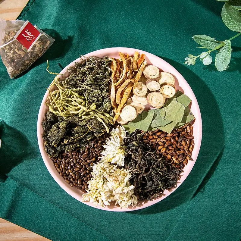 Assorted dried herbs and roots in a pink bowl for traditional Chinese medicine colon cleansing tea