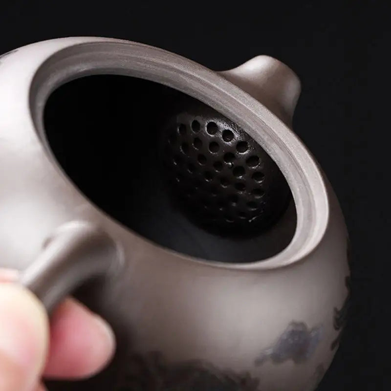 Color-changing dragon zisha teapot with internal strainer and phoenix design