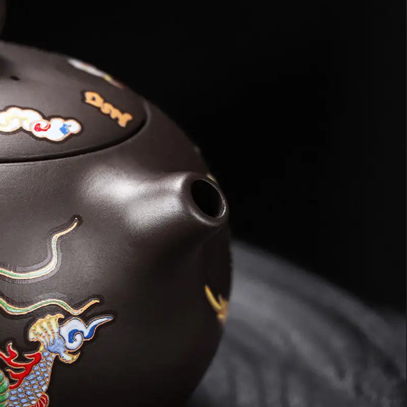 Ornate brown Zisha teapot featuring a color-changing dragon and phoenix design
