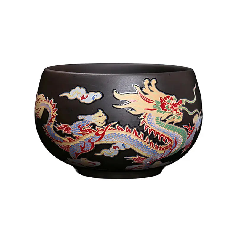 Black ceramic Yixing Zisha tea cup with color-changing dragon design for tea ritual drinking