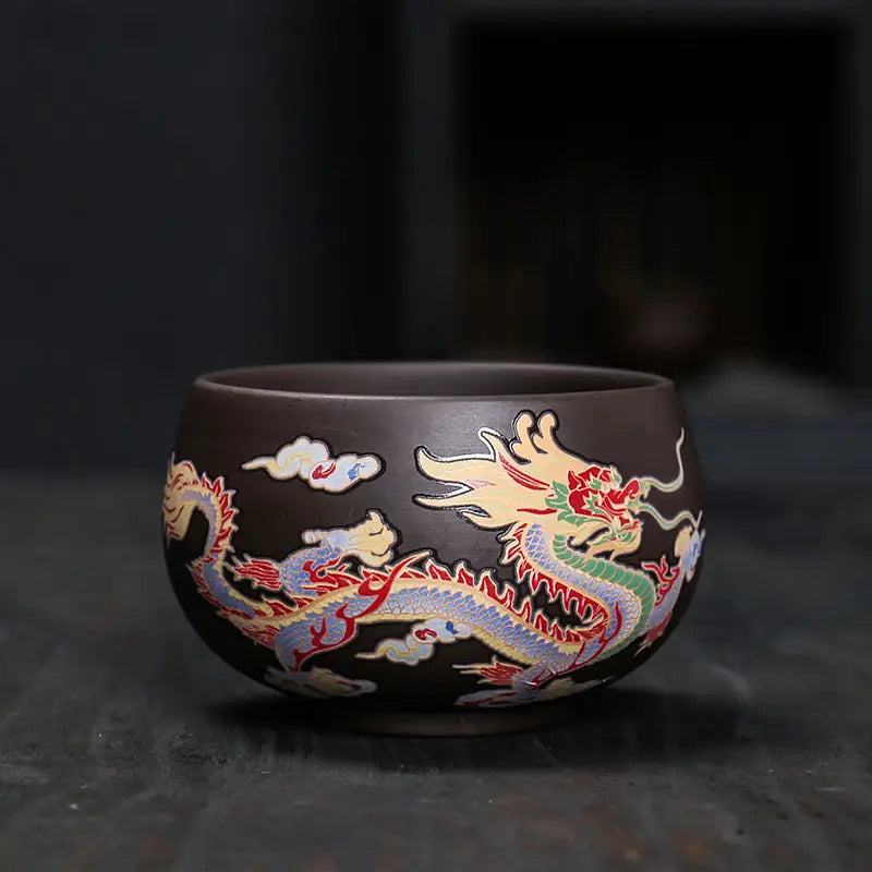 Brown ceramic Yixing Zisha tea cup with colorful color-changing dragon design for tea ritual drinking