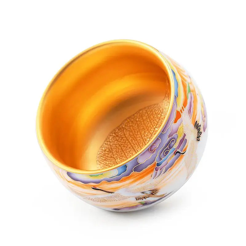 Ornate golden bowl from Colorful Cranes with a hand-painted porcelain teacup design