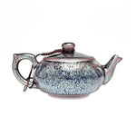 Glazed ceramic Jian Zhan Comet Teapot with celestial glaze showcasing elegant design
