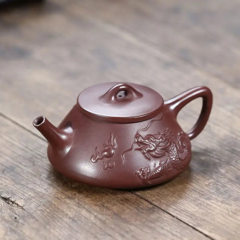 Maroon Yixing Zisha teapot with intricate creative dragon design for a unique Yixing teapot