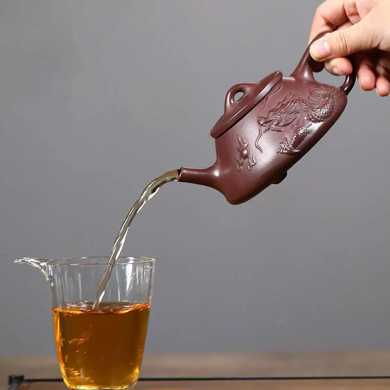 Dragon-embossed brown Yixing Zisha teapot pouring tea from Creative Dragon collection