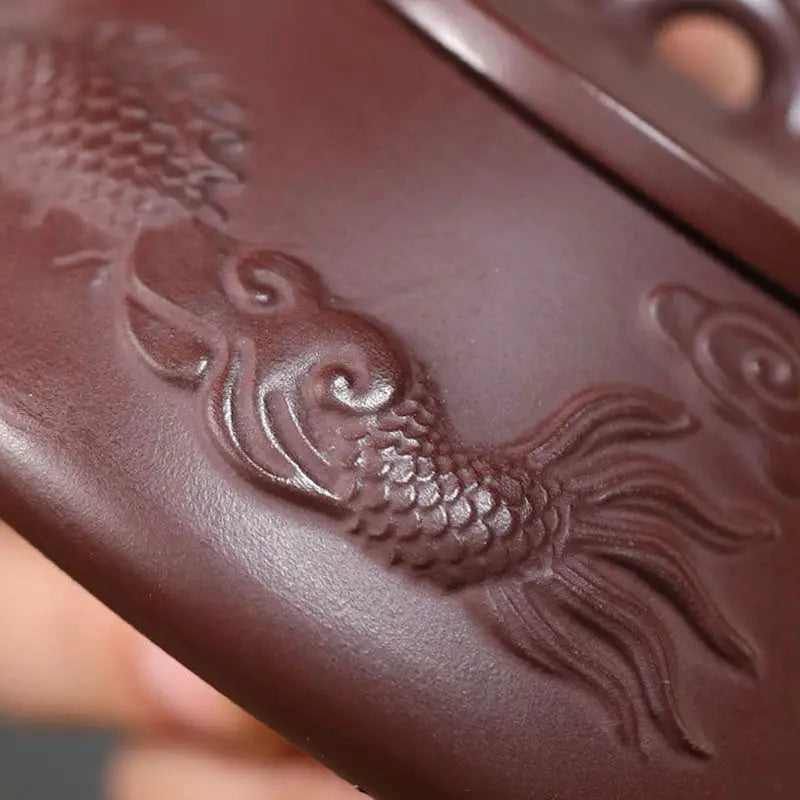 Embedded fish design on Yixing Zisha brown surface in Creative Dragon Yixing Teapot