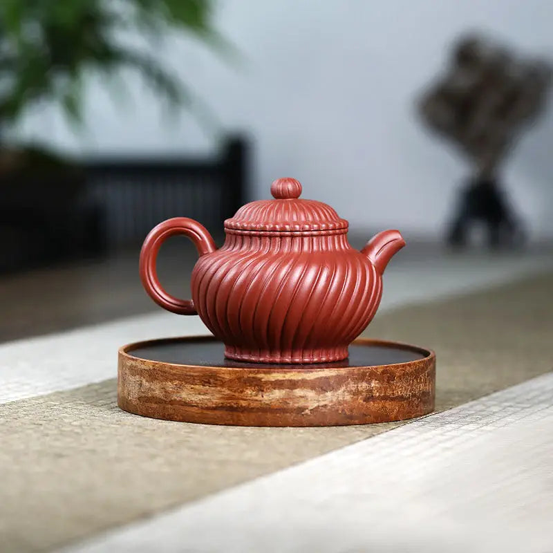 Red-brown ridged ceramic teapot from Crimson Spiral harmony, a handmade Yixing Zisha teapot