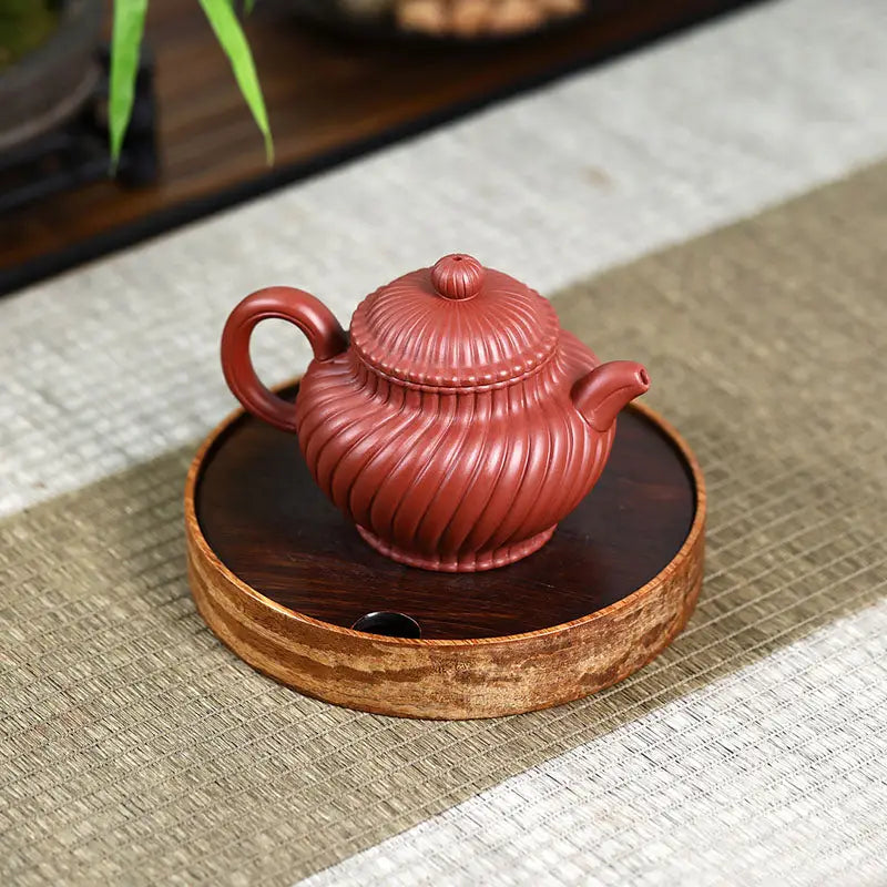 Reddish-brown ridged ceramic teapot from Crimson Spiral harmony, a handmade Yixing Zisha teapot