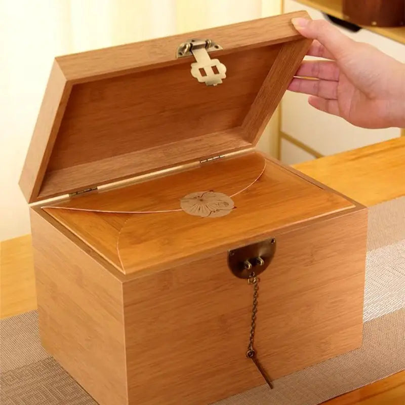 Open wooden box with metal accents for Da Jin Zhong Black Tea Leaves, ideal for tea sets