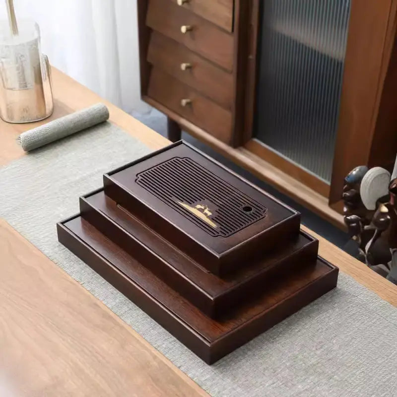 Stacked dark wooden tea trays from Deer Whisper bamboo gongfu tea collection
