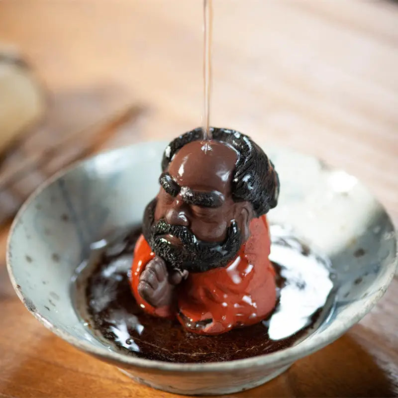 Karl Marx chocolate bust displayed as Dhyana Guardian Zisha Tea Pet on Yixing Zisha pottery