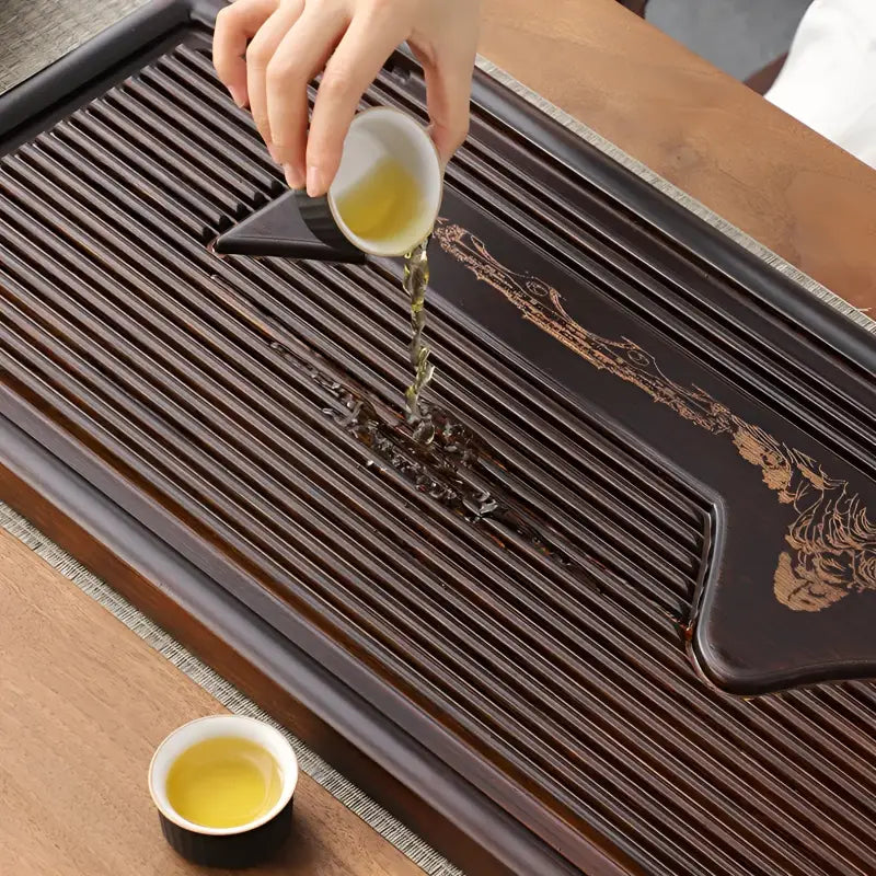 Dark wooden tea tray with drainage slats from Distant Mountains for gongfu tea brewing