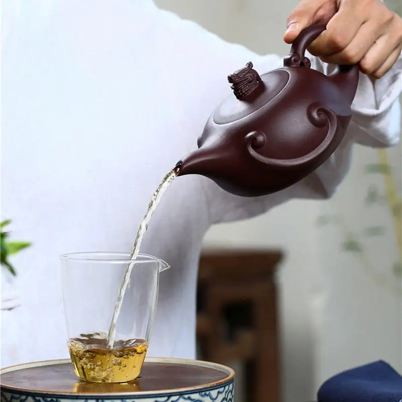 Brown Dragon Crest teapot pouring tea, sculpted dragon Yixing Zisha 220ml crest teapot