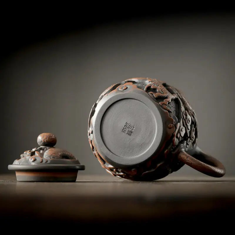 Ornate brown Dragon King Jianshui Zitao teapot with lid, crafted in Jianshui pottery