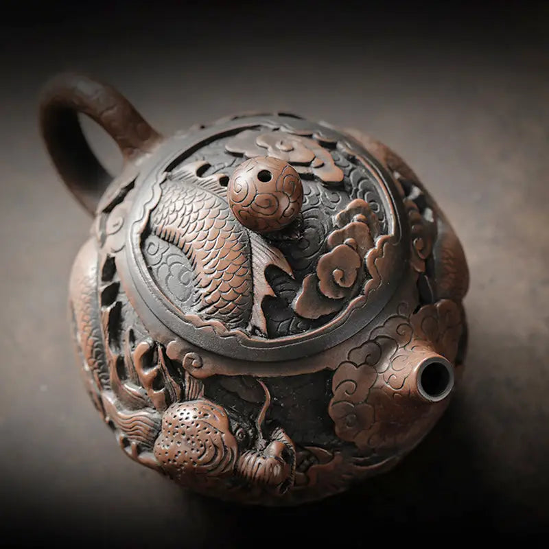 Ornate hand-carved Jianshui Zitao clay teapot with dragon and cloud motifs for Dragon King
