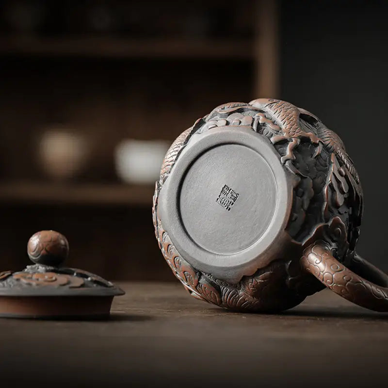 Ornate dragon-themed teapot with lid crafted from hand-carved Jianshui Zitao clay featuring dragon symbolism