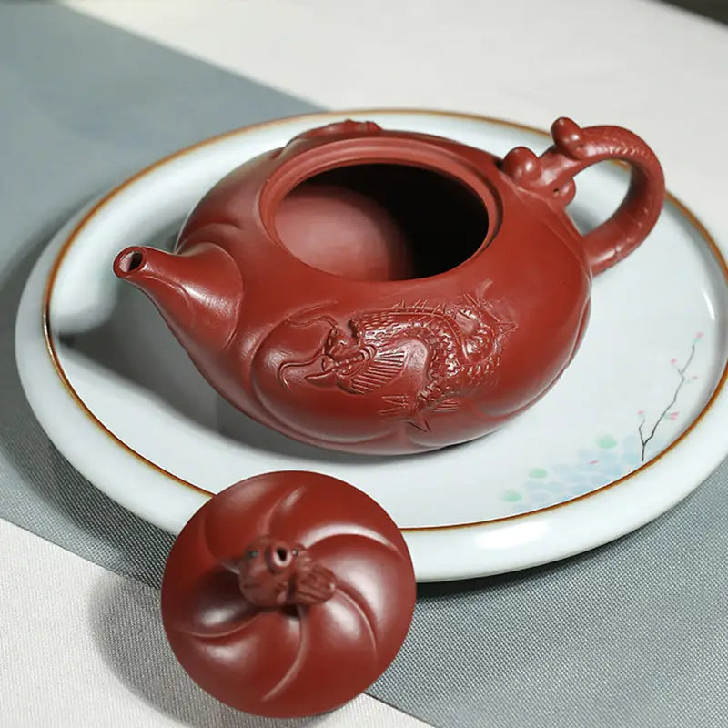 Reddish-brown Yixing teapot with dragon and carp ascending design in Yixing Zisha clay