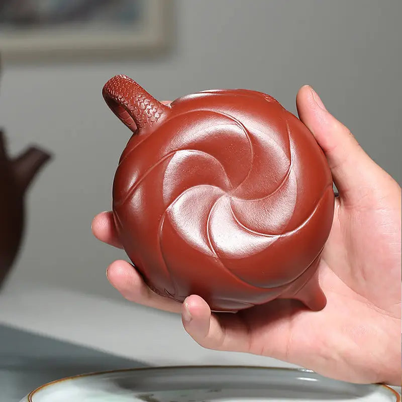 Reddish-brown swirling-patterned Yixing Zisha clay teapot with carp ascending design