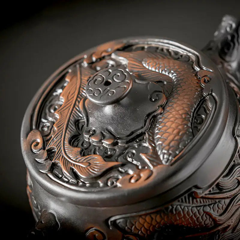 Ornate dragon-themed teapot lid on Dragon & Phoenix jianshui zitao teapot for purple clay gongfu tea