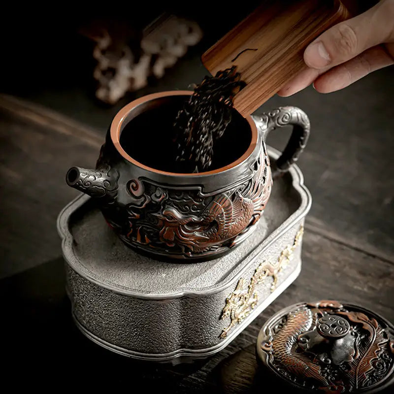 Ornate metal dragon design on Zitao tea pot from the Dragon & Phoenix collection
