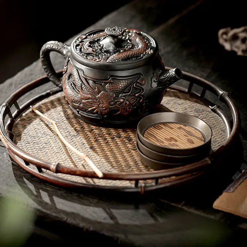 Dragon-themed jianshui zitao teapot with matching coasters for purple clay gongfu tea moments