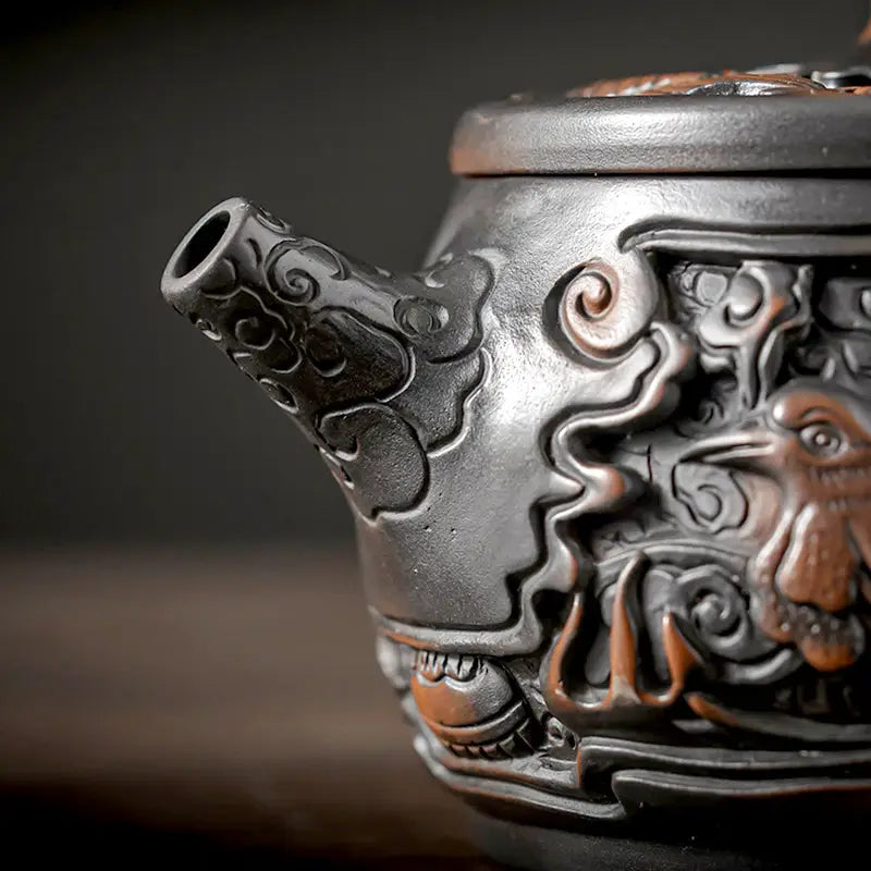 Ornate black Jianshui Zitao teapot with dragon spout from Dragon & Phoenix, perfect for purple clay Gongfu tea