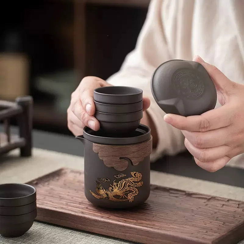 Six stackable cups nesting inside the portable Zisha teapot