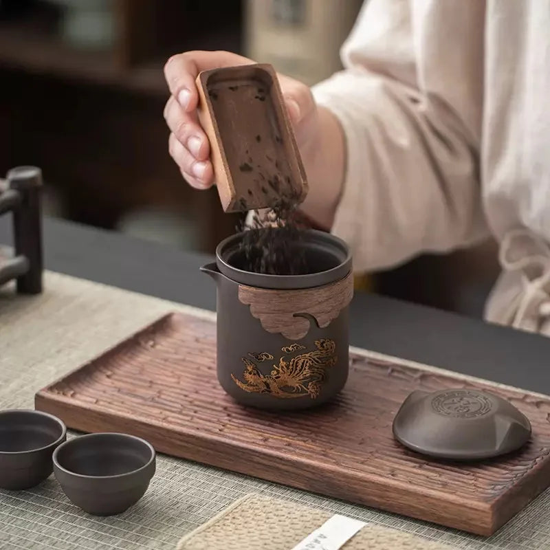 Loose tea leaves being added to the portable Zisha teapot