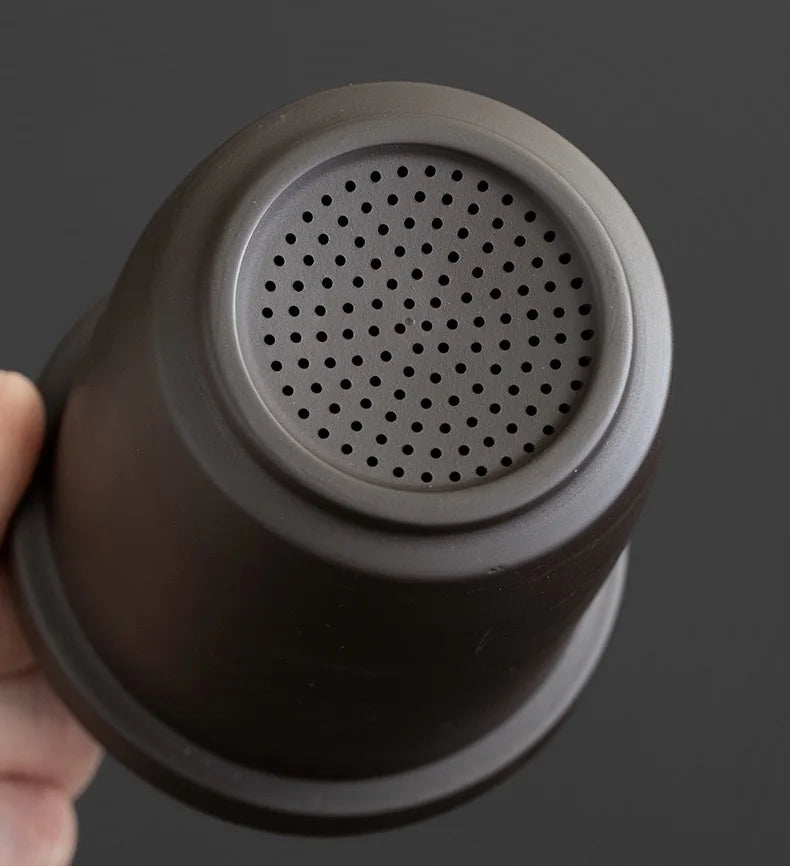Perforated infuser inside the portable Zisha teapot