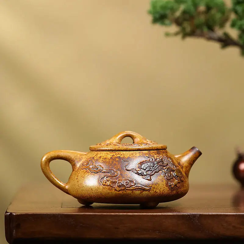 Ornate brown Yixing teapot with dragon carvings made from Duanni clay in Dragon Root