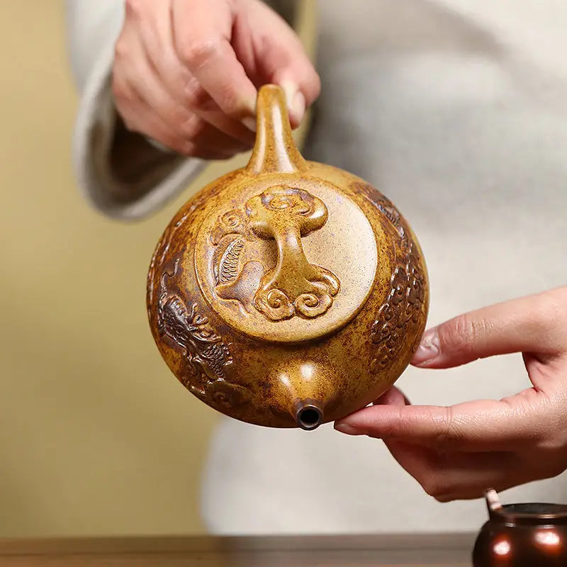 Ornate gourd-shaped Yixing teapot with dragon carvings made from Duanni clay