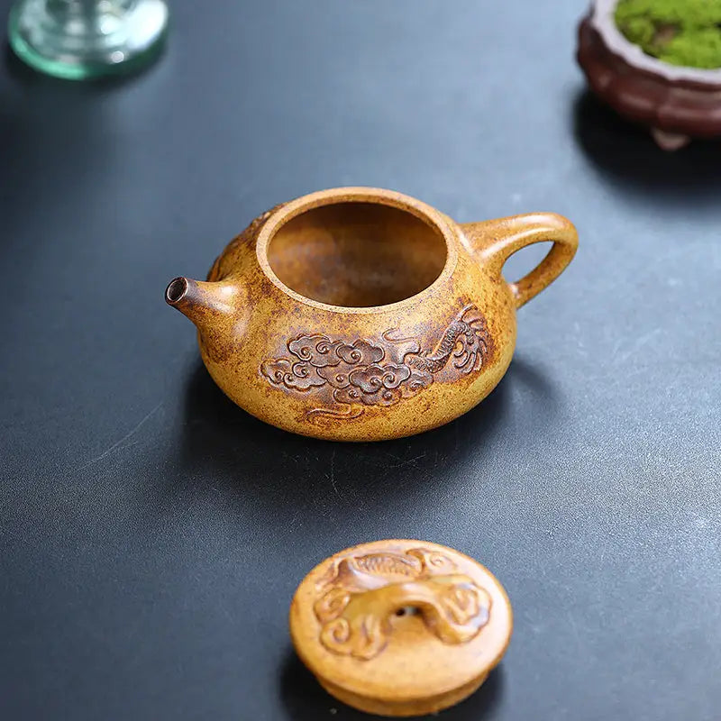 Ornate yellow-brown Yixing teapot with dragon carvings made from Duanni clay for Dragon Root