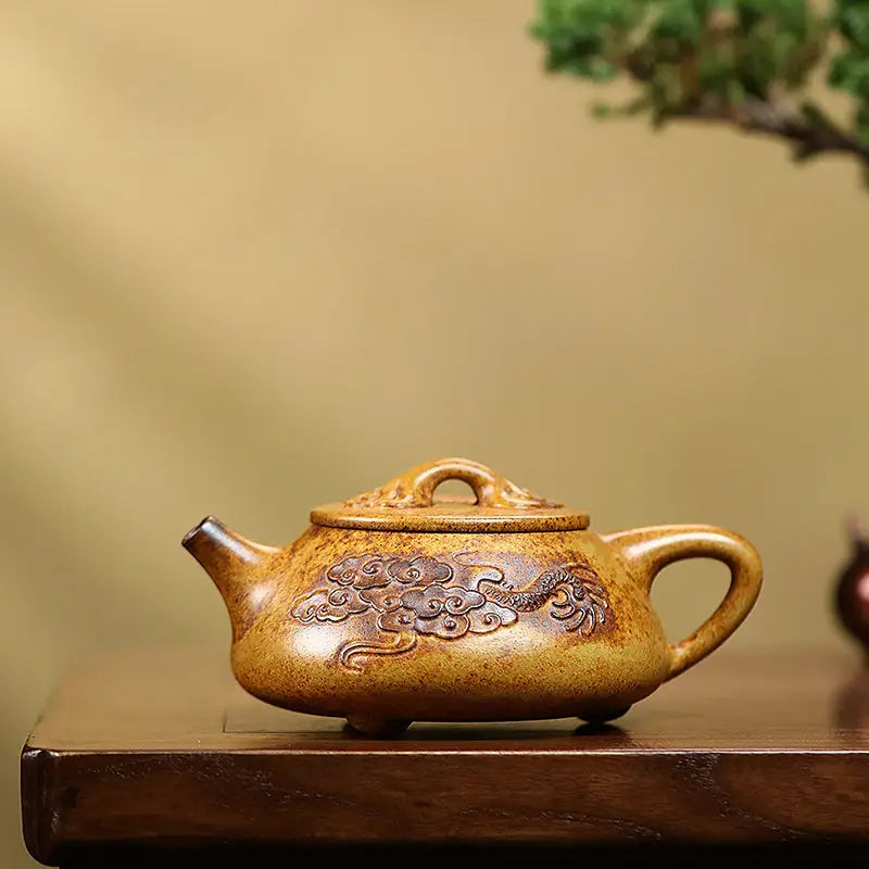 Ornate brown Yixing teapot with dragon carvings made from Duanni clay in Dragon Root