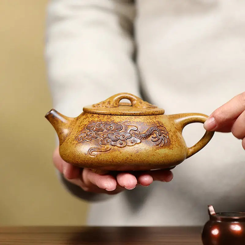 Ornate brown Yixing teapot with dragon carvings made from Duanni clay in Dragon Root