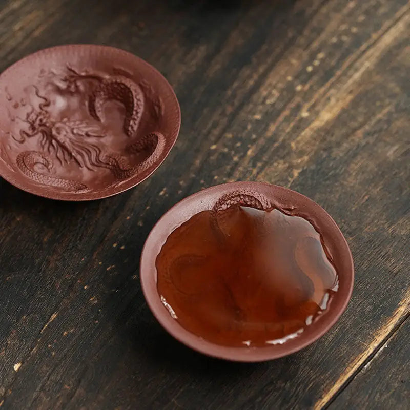 Two brown dragon spirit teacups featuring intricate dragon designs for a unique tea experience