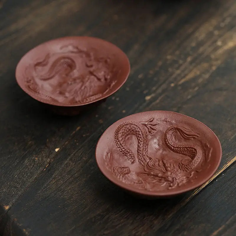Two brown dragon-embossed Spirit Teacups from Dragon Spirit for elegant tea moments