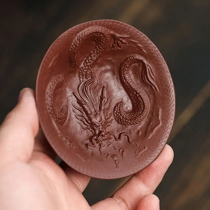 Circular dragon-embossed clay plate from Dragon Spirit teacup collection for elegant serving