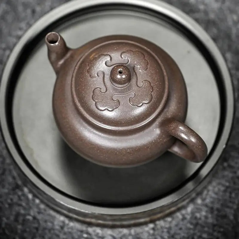 Brown ceramic teapot on Dragon Tripod Yixing Zisha Yixing Teapot collection