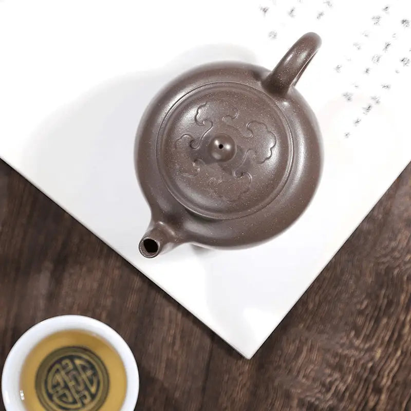 Brown ceramic teapot on Dragon Tripod Yixing Zisha Yixing Teapot for brewing tea