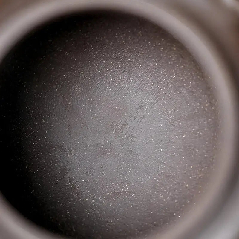Dark textured spherical interior of Dragon Tripod showcasing Yixing Zisha craftsmanship