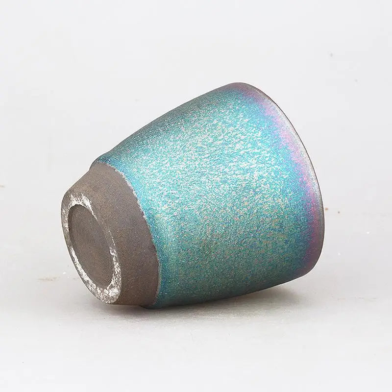 Iridescent teal ceramic cup from Jian Zhan Tenmoku Ceramics displayed in the Dream product