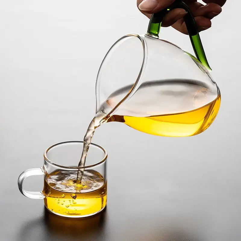 Glass pitcher pouring tea from Eagle Beak handblown high-borosilicate glass