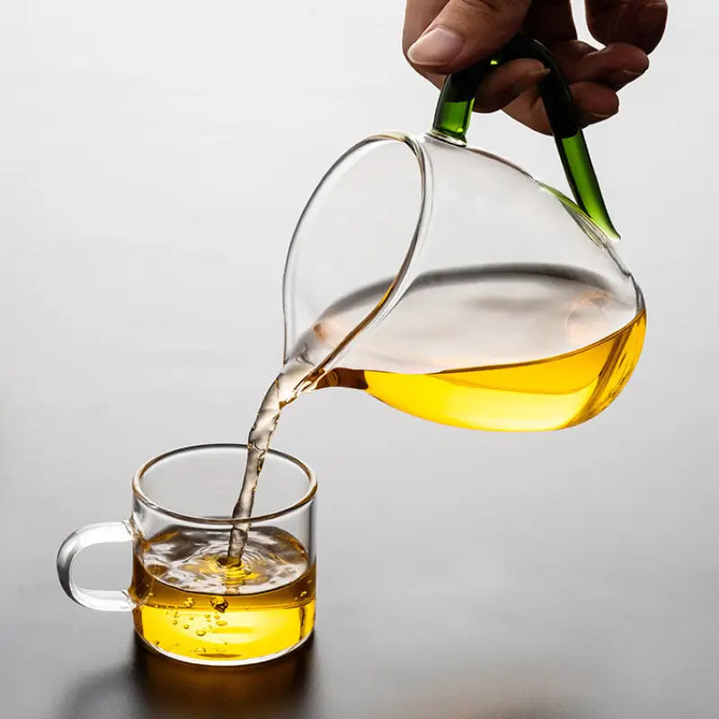 Glass pitcher pouring tea from Eagle Beak, made of handblown high-borosilicate glass